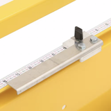 Metal ruler with measurement markings on a yellow background